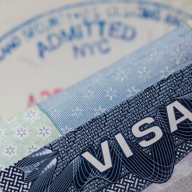 Close up of a Visa spamp in a passport. Immigration and emigration concept
