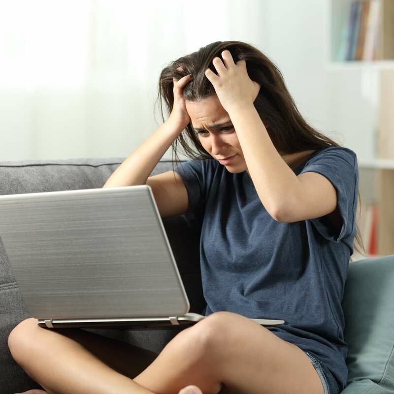 Canva - Worried teen reading bad news online at home-min